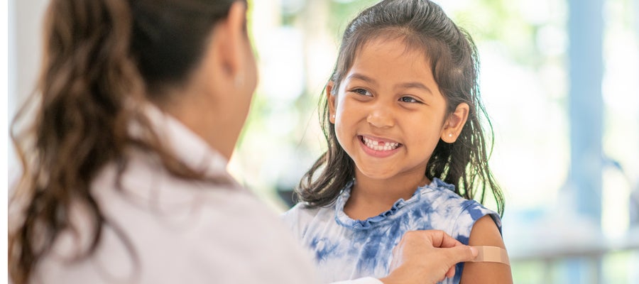 Child with post-shot Bandaid on arm